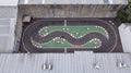 Apex GP rear car park track — serpentine MiniGP circuit, aerial view